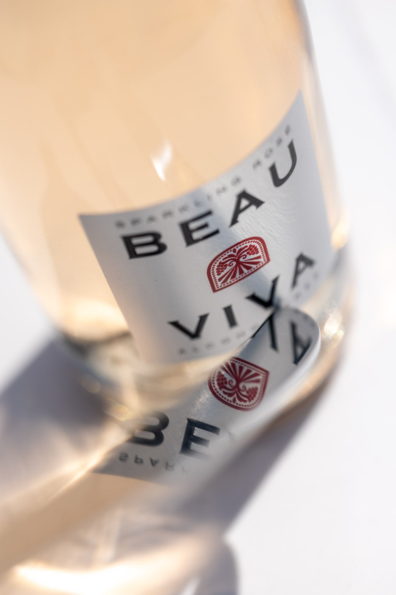 Close-up of Beau Viva rosé wine label and reflection