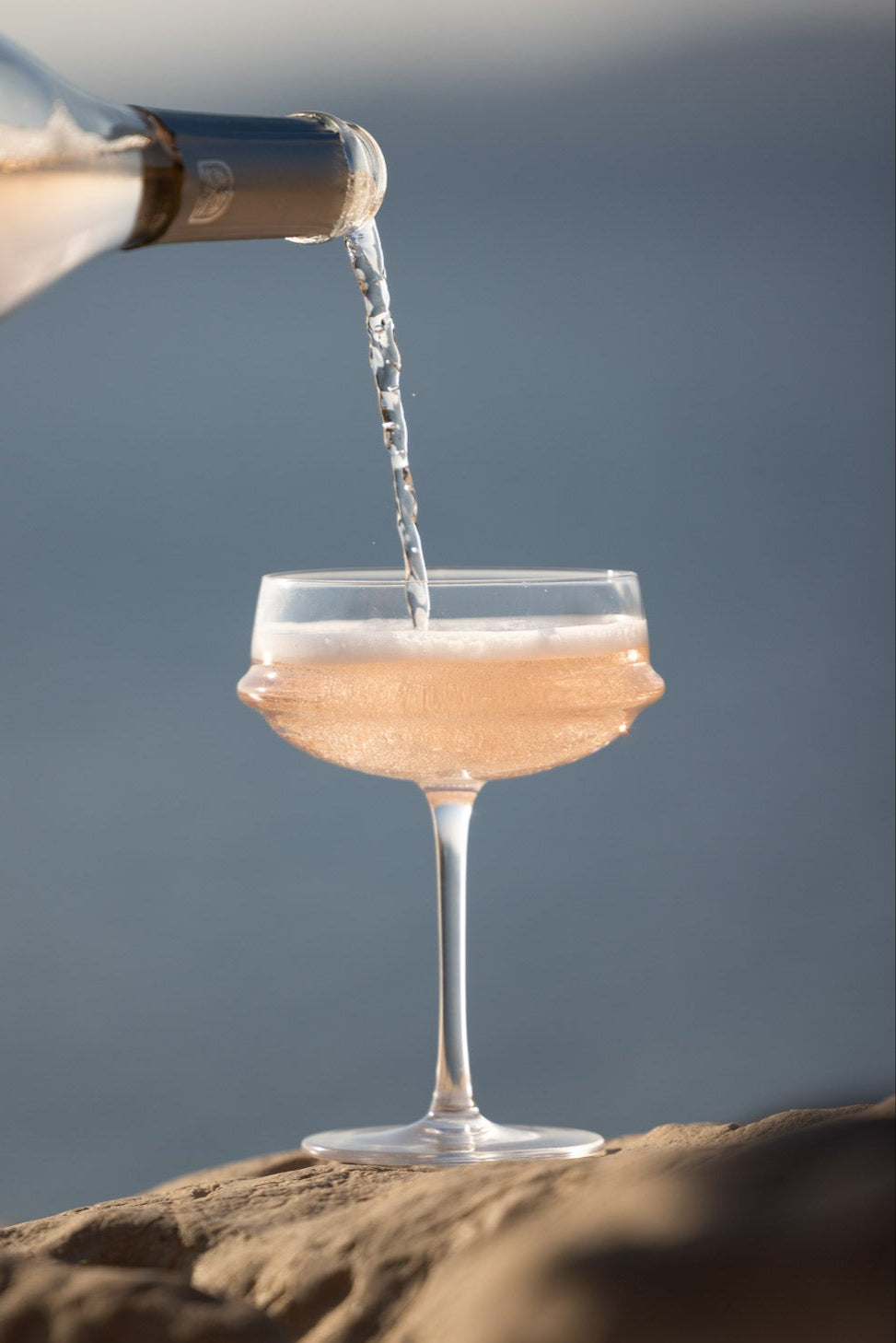 Pouring alcohol-free rosé into glass