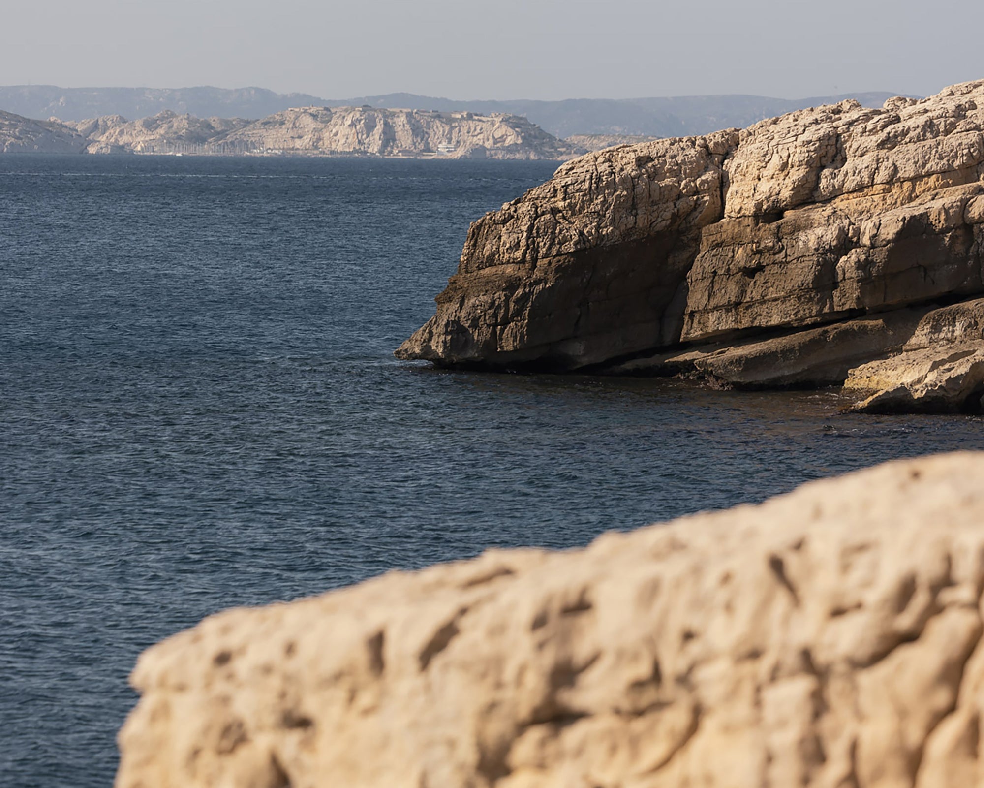 Cliffs and sea in the South of France with Beau Viva tagline
